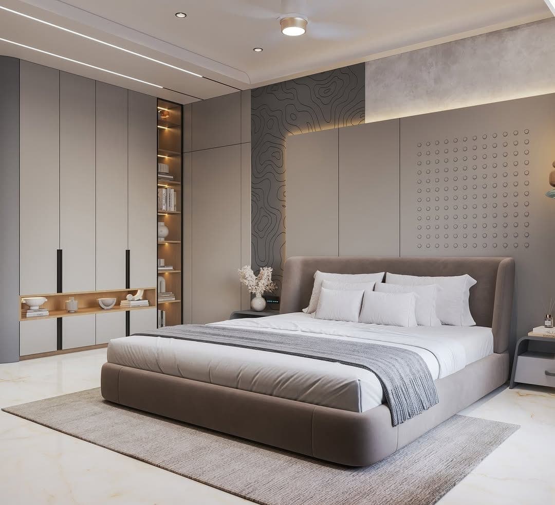 Bedroom with an upholstered bed, textured wall panelling and a full-height fitted wardrobe