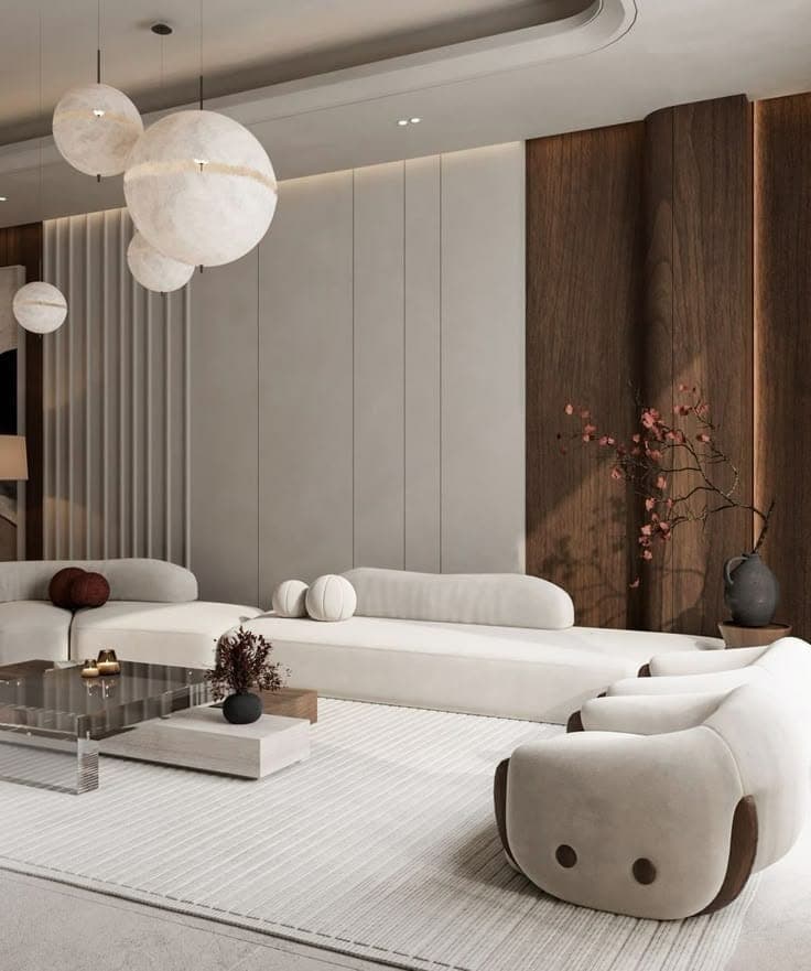 Contemporary living room with fluted wall panelling, sculptural pendant lights and low cream seating