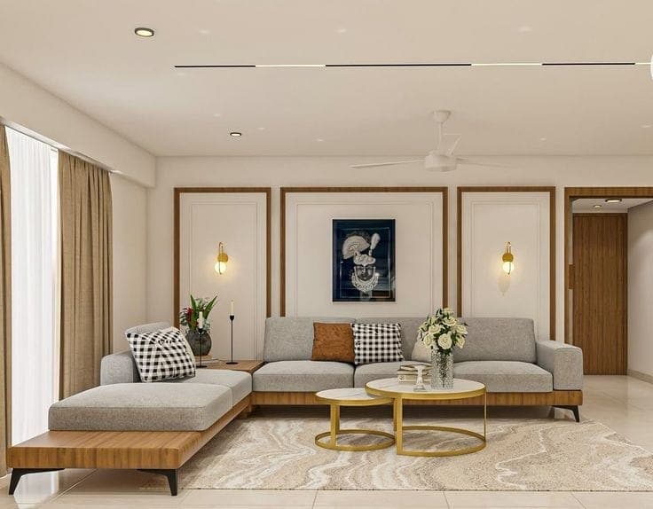 Living room with a low sectional sofa, paired gold coffee tables and panelled feature walls