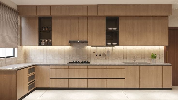 Light oak modular kitchen with full-height tall units and a marble backsplash